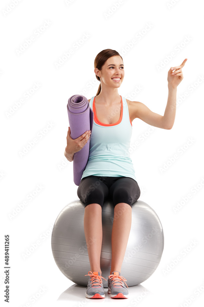 Find your motivation and dont lose it. Shot of a young woman pointing at something in a studio with 