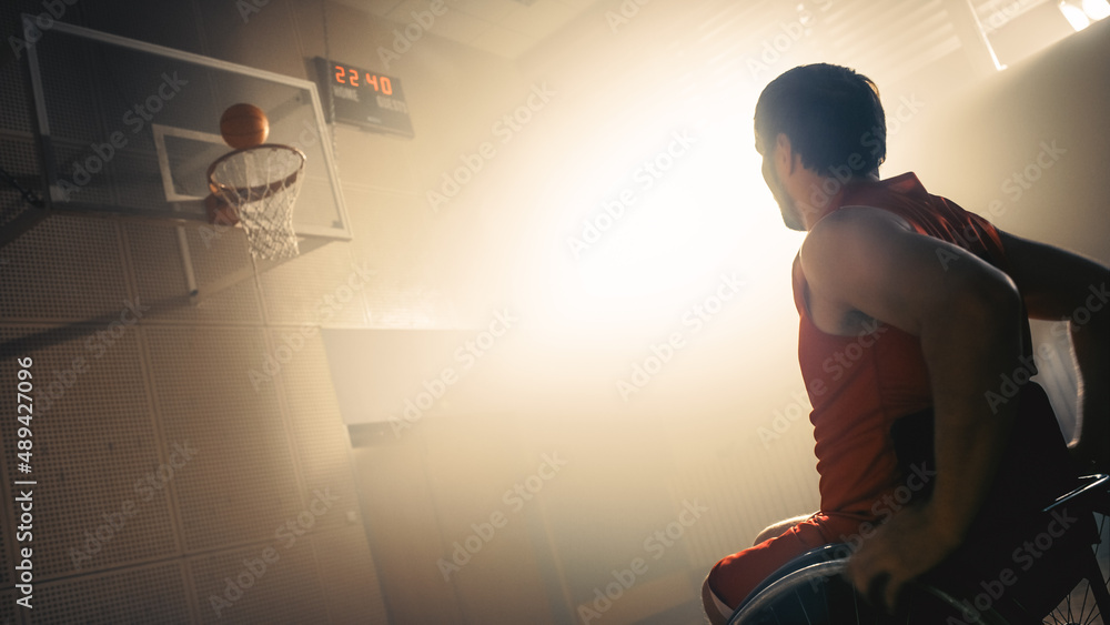 Wheelchair Basketball Player Wearing Red Uniform Shooting Ball Successfully, Scoring a Perfect Goal.