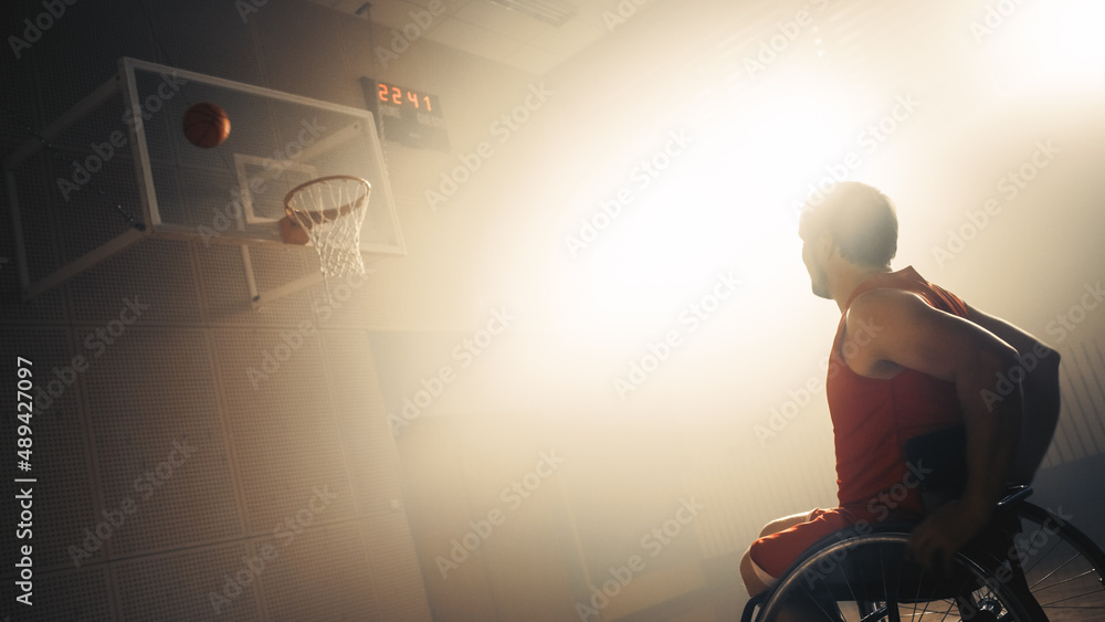 Wheelchair Basketball Player Wearing Red Uniform Shooting Ball Successfully, Scoring a Perfect Goal.