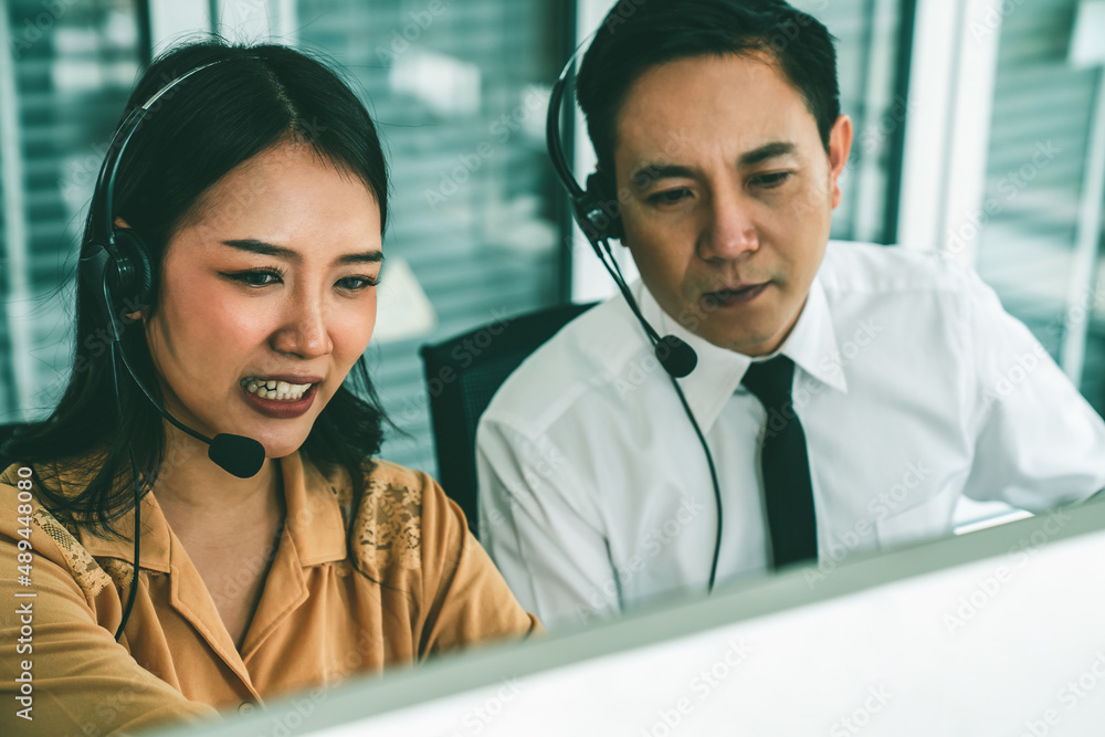 Business people wearing headset working actively in office . Call center, telemarketing, customer su