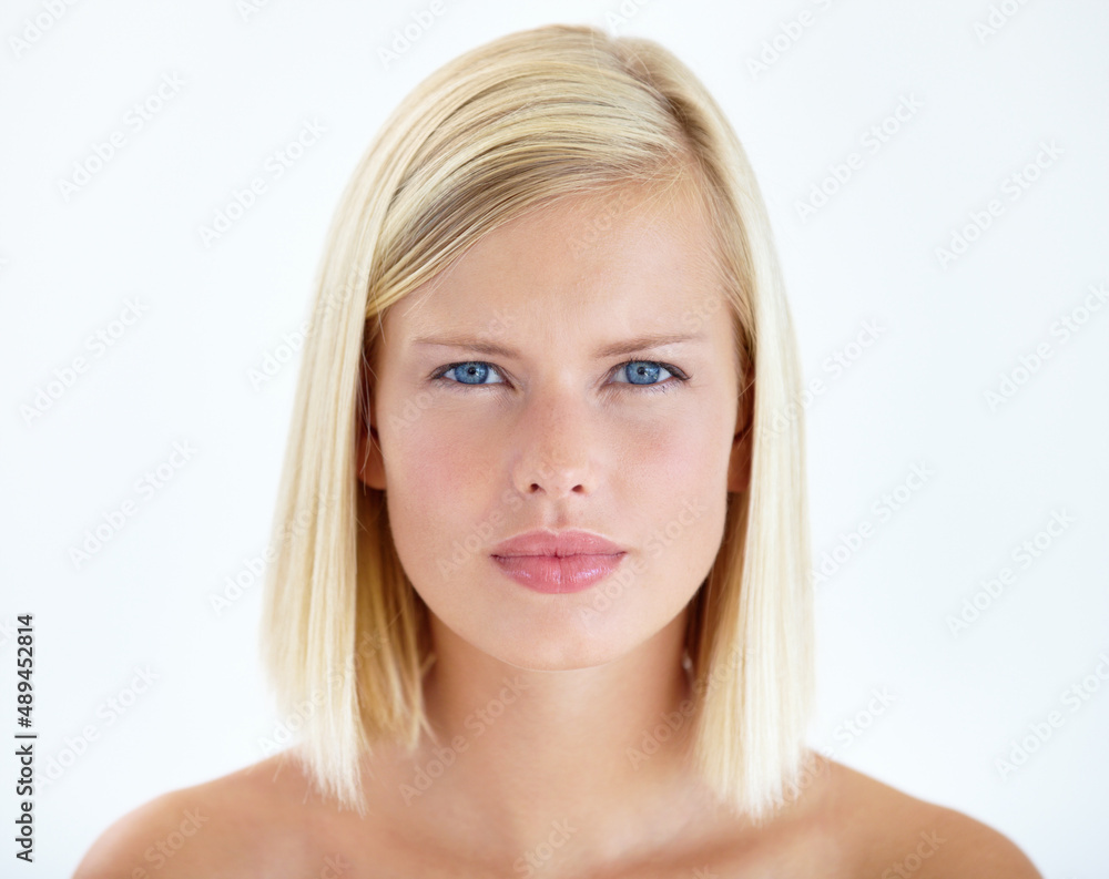 Framing natural beauty. Head and shoulders portrait of a pretty young blonde staring at your serious