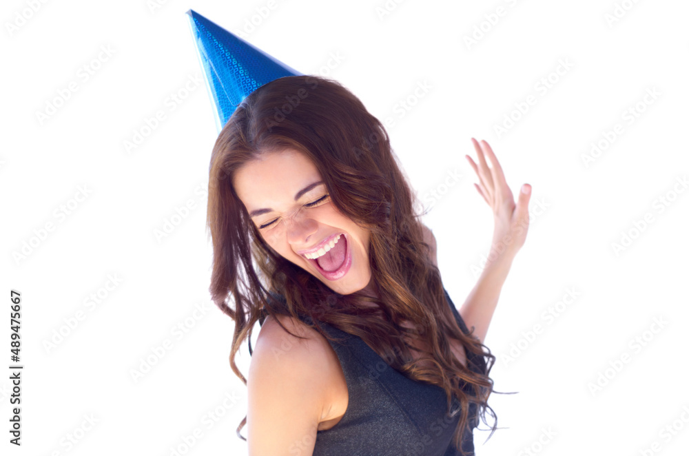 Shes a party girl. An attractive young woman dancing while wearing a party hat.