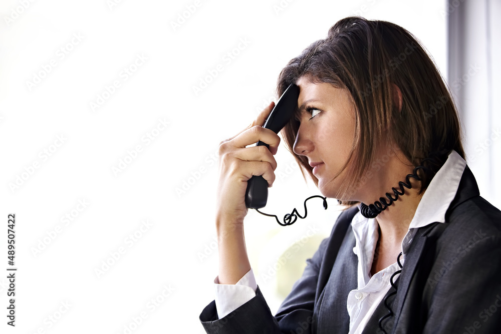 The call that ruined her day.... A bored businesswoman with a phone pressed to her head and the cord