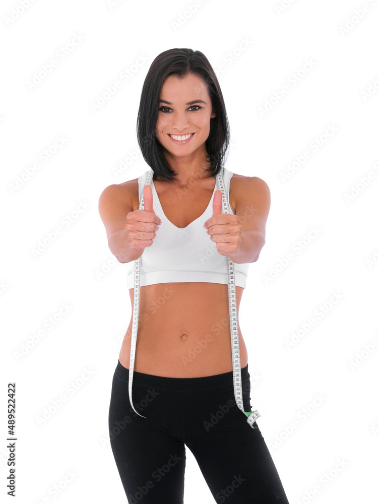 I did it - Fitness Weight loss. A fit young woman giving two thumbs up while isolated on white with 