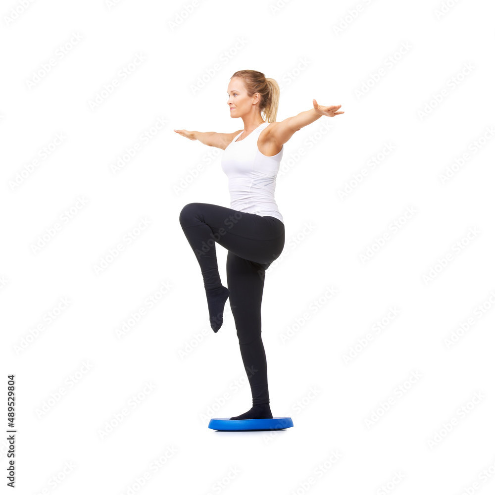 Crane pose. Full length studio shot of a beautiful young woman doing balance exercises isolated on w