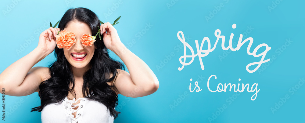 Spring is coming message with young woman holding carnation flowers