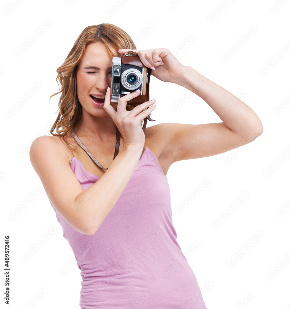 Youre so photogenic. Studio shot of a young woman taking a picture with a vintage camera.