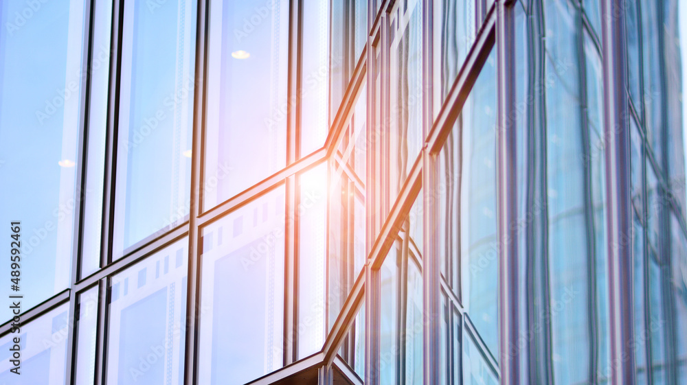 Glass facade of a modern housing construction with of balconies.