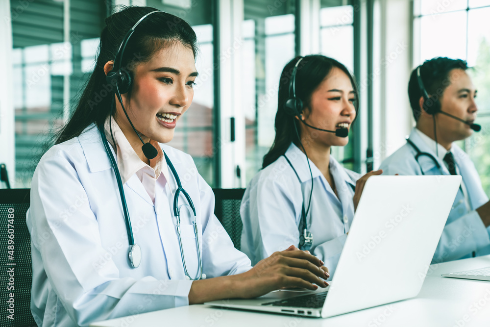 Doctor team wearing headset talking actively on video call in hospital clinic . Concept of telehealt