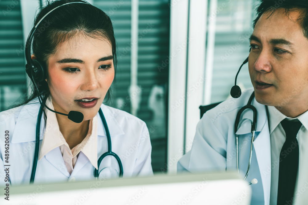 Doctor team wearing headset talking actively on video call in hospital clinic . Concept of telehealt