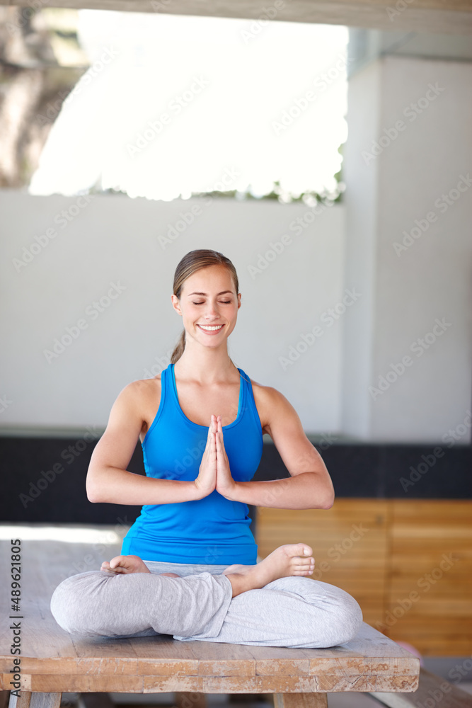 Inner peace is all she needs. A young woman enjoying a relaxing yoga class.