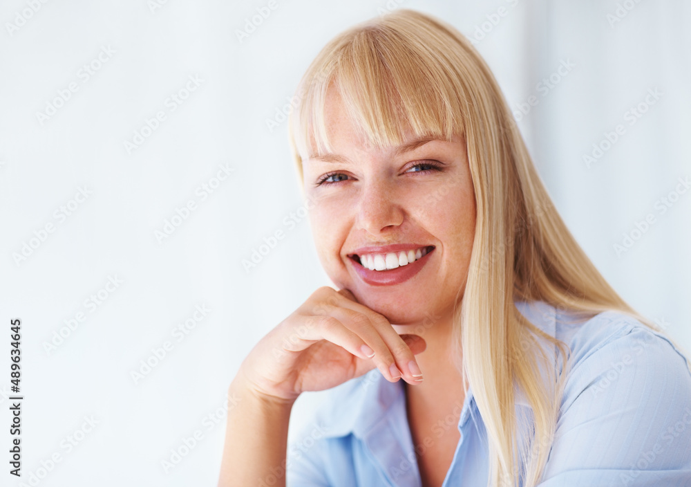 Business woman posing with hand on chin. Young business woman with hand on chin over white backgroun