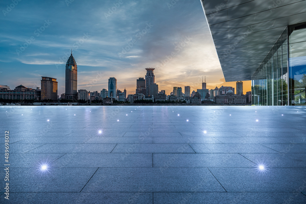 Empty square floor and city skyline with buildings in Shanghai at sunset, China.