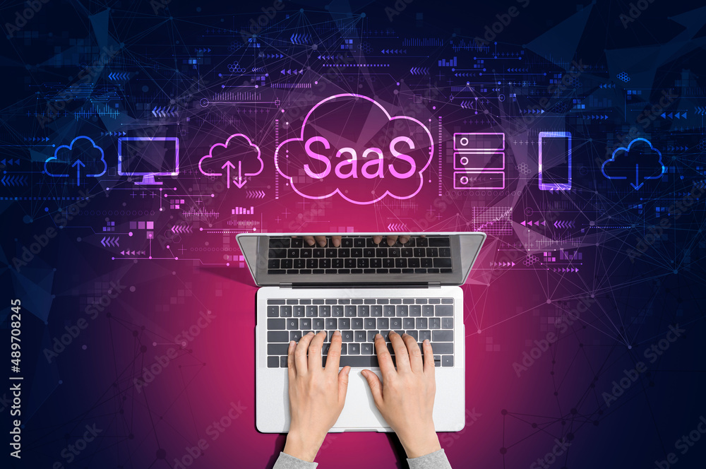 SaaS - software as a service concept with person using a laptop computer