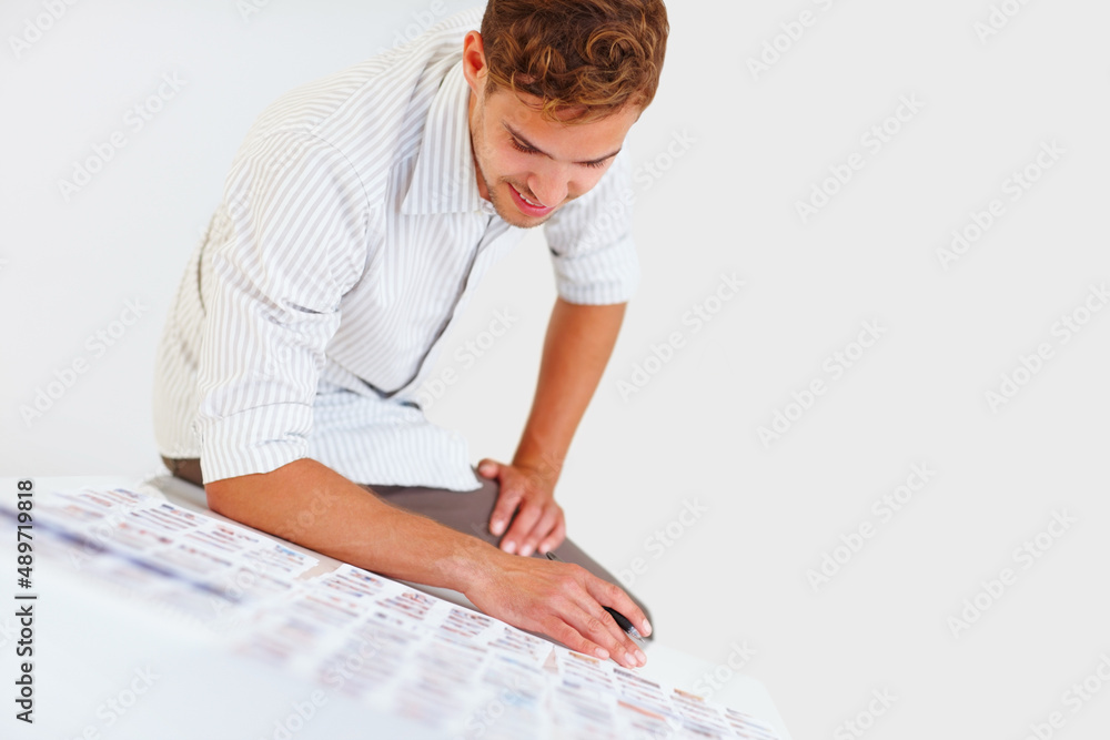 Male photographer sitting on table. Male photographer sitting on table and looking at his photos.