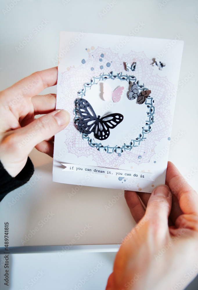 Admiring home handywork. Cropped shot of a womans hands holding a hand-made card.