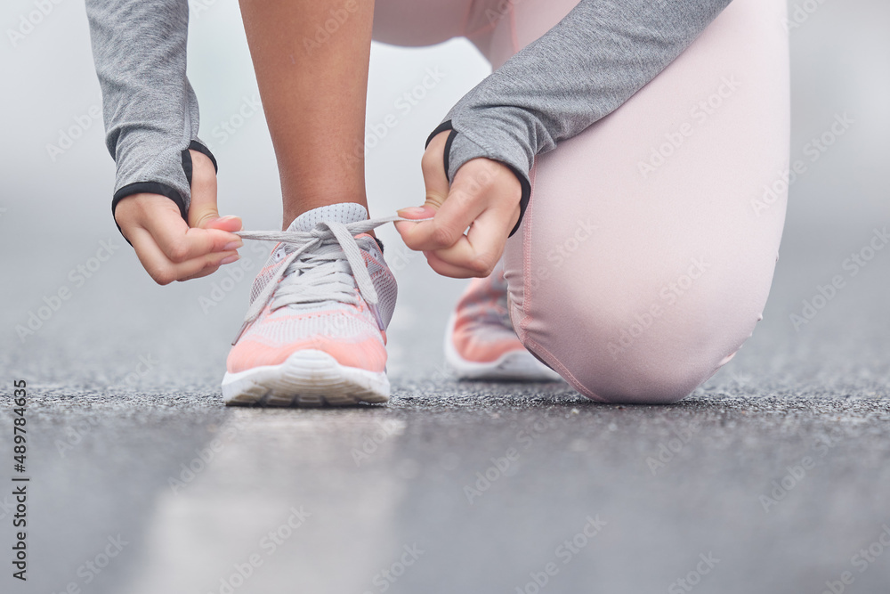 Stay focused on your end goal. Closeup shot of an unrecognizable persn tying their shoelaces while e