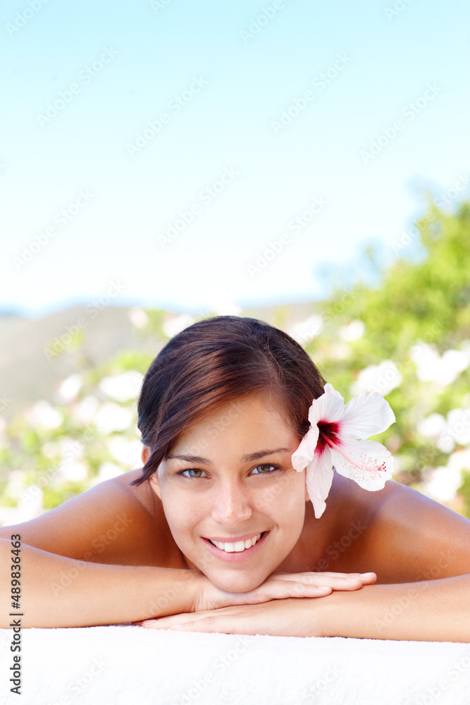 Relaxing with a smile. Smiling young woman lying in a day spa.