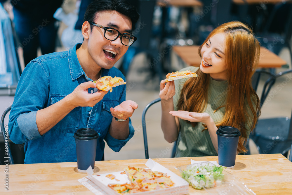 Young Asian couple having lunch together in cafe