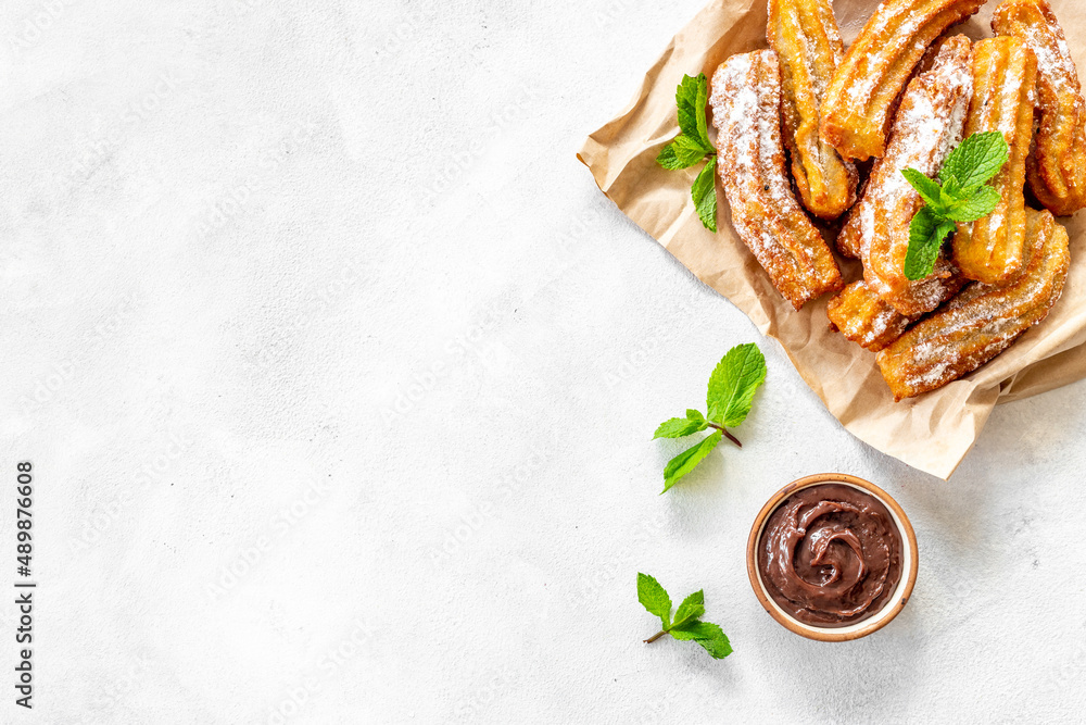 Churros fried pastry with chocolate sauce. Street food dessert