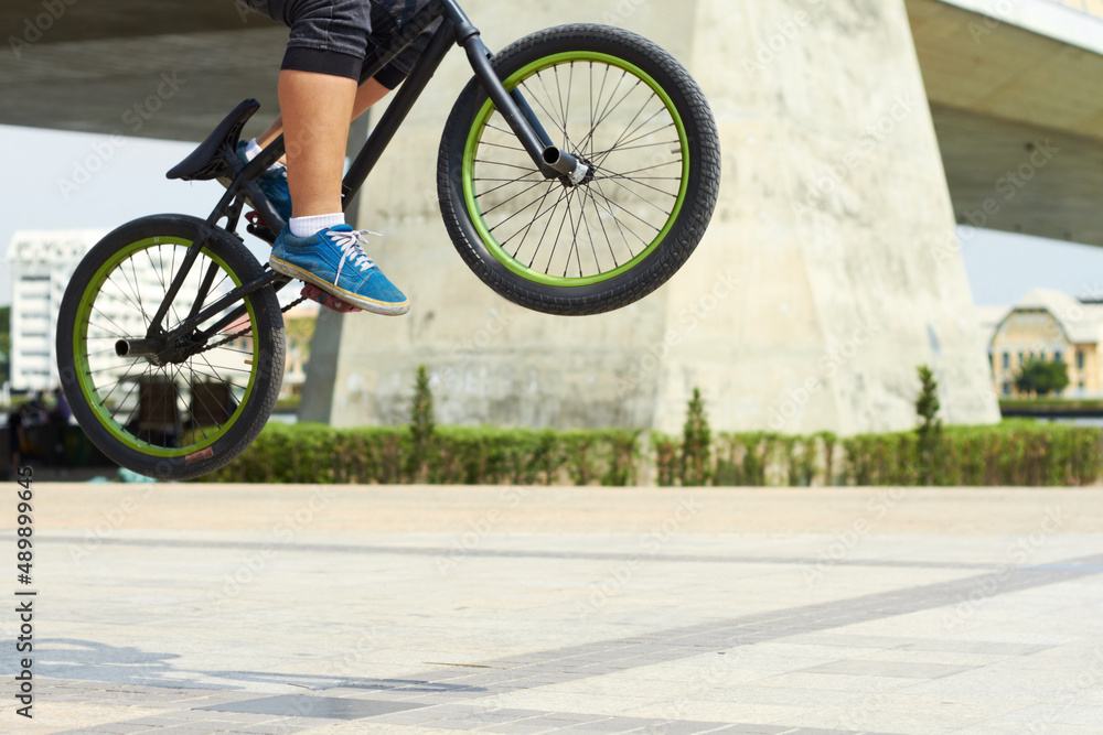 Hell risk to fall just to fly. A BMX rider doing tricks out in the city.