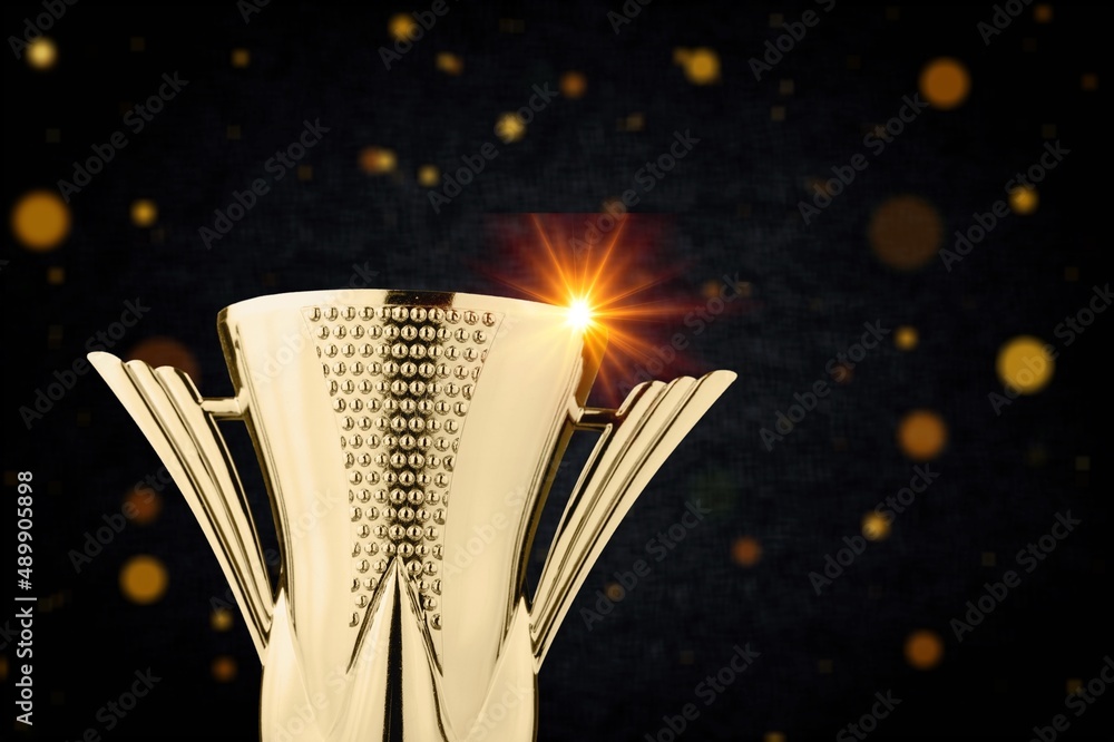 Golden metal trophy cup. Festive light background.