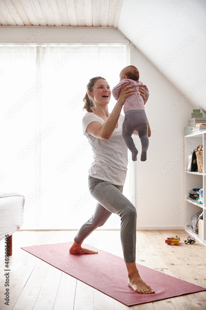 Body conscious mom and baby. Shot of an attractive young woman bonding with her baby girl while doin