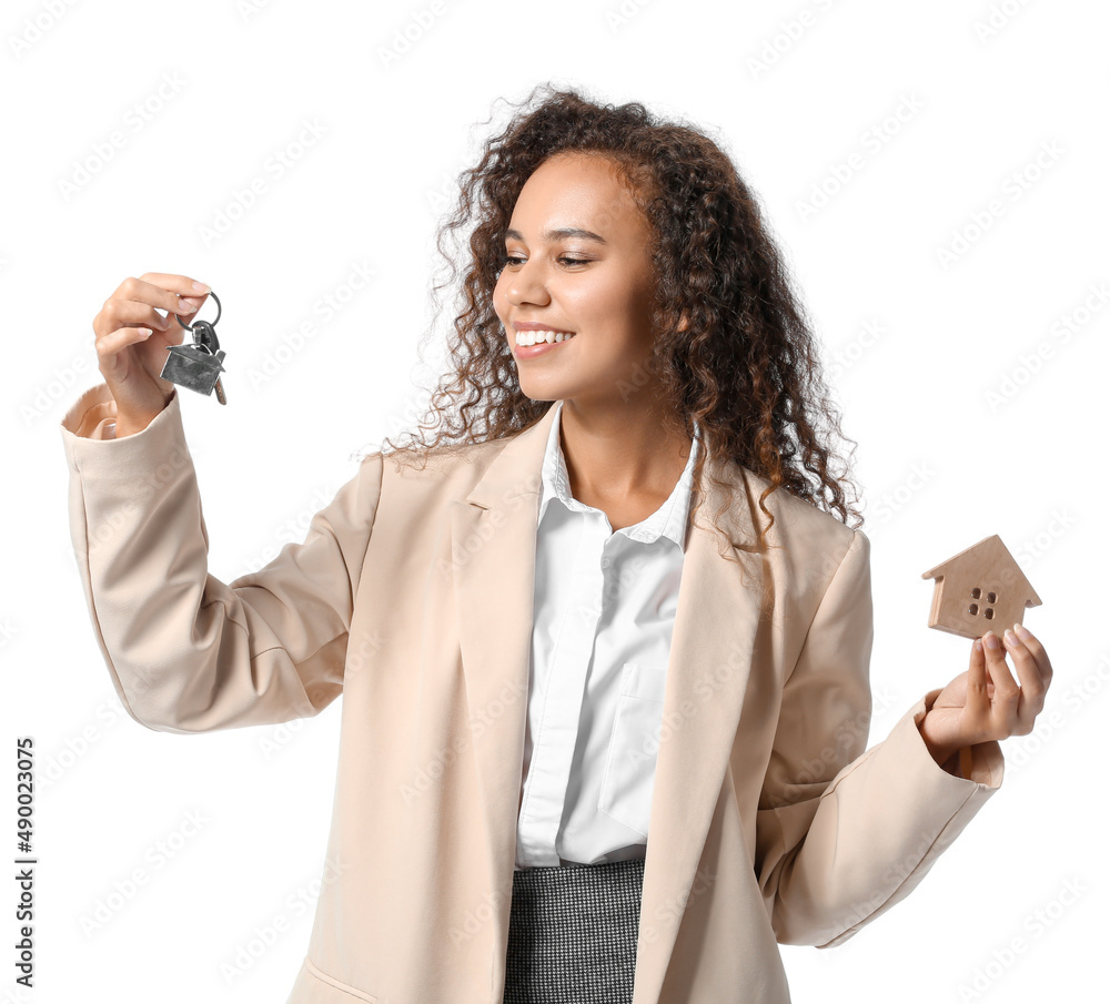 African-American real estate agent with figure of house and key on white background