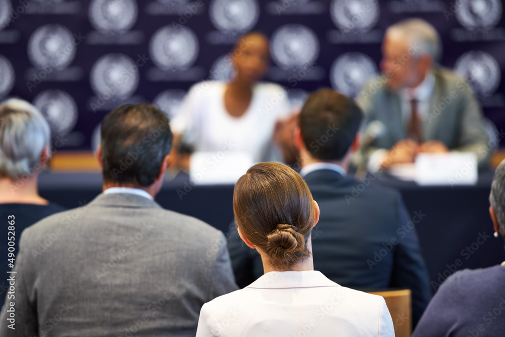 Giving their statement to the public. Shot of a group of businesspeople in a press conference.