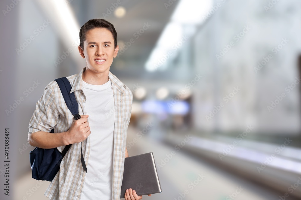 Happy young student at the university background