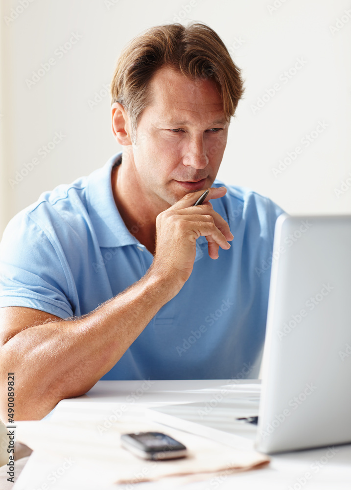 Waiting for inspiration. Shot of a mature man concentrating on his computer screen.