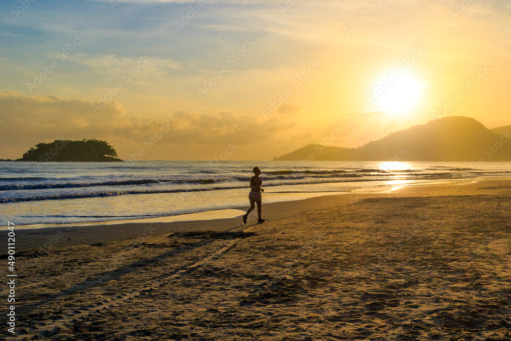 running in sunset at the beach of Balneário Camboriú