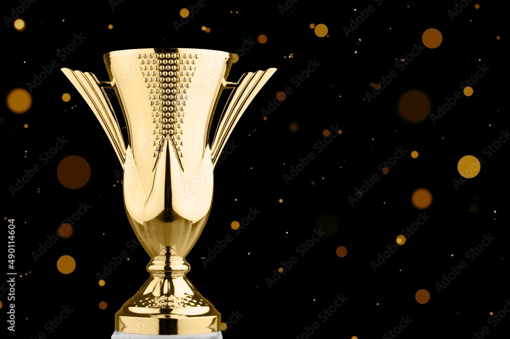 Golden metal trophy cup. Festive light background.