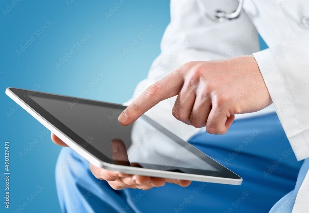 Beautiful young doctor, with a tablet for records. Medical student general practitioner. The concept