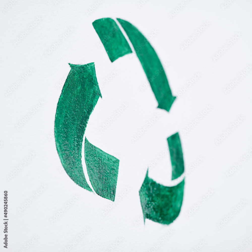 The way to tomorrow starts with a cleaner today. Shot of a green recycle symbol painted on a wall.