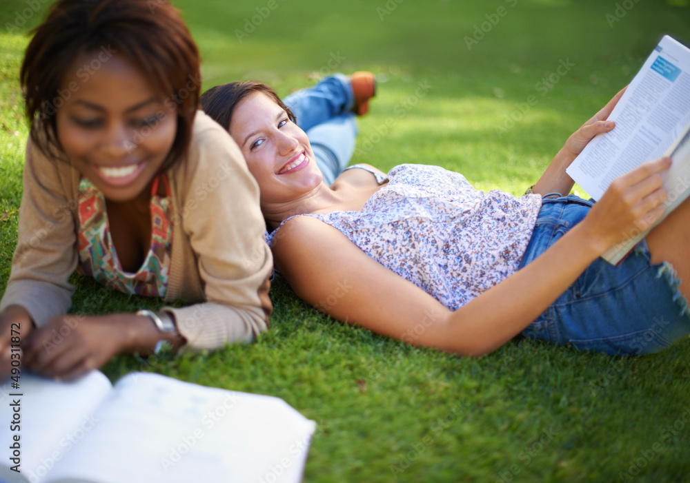 Carefree college days. Cropped shot of a two beautiful young college students studying outside.