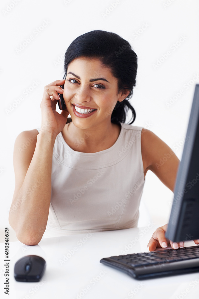 Female executive talking on cell phone. Attractive female executive talking on cell phone while work