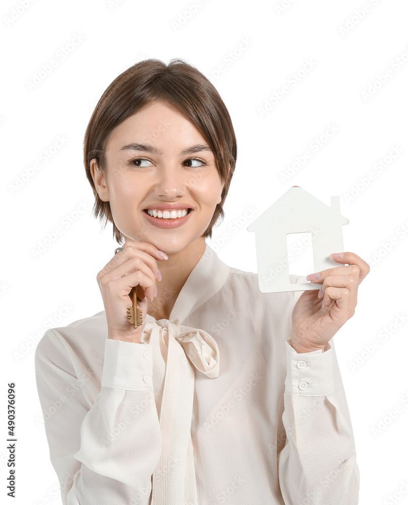 Female real estate agent with figure of house and key on white background