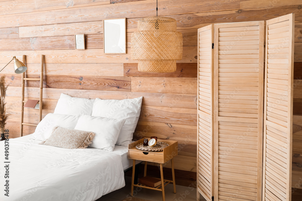 Interior of modern bedroom with wooden wall