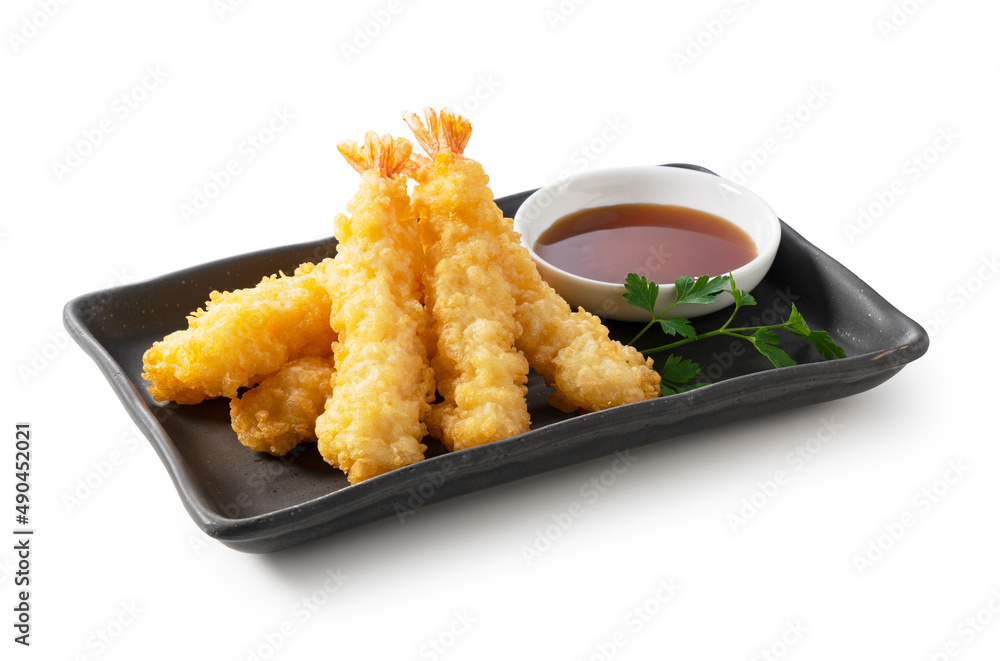 Shrimp tempura on a plate placed on a white background.