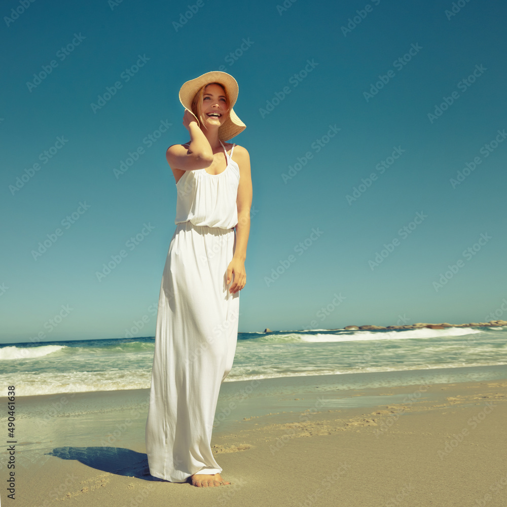 Seaside styling. Shot of a beautiful young woman enjoying a day at the beach.