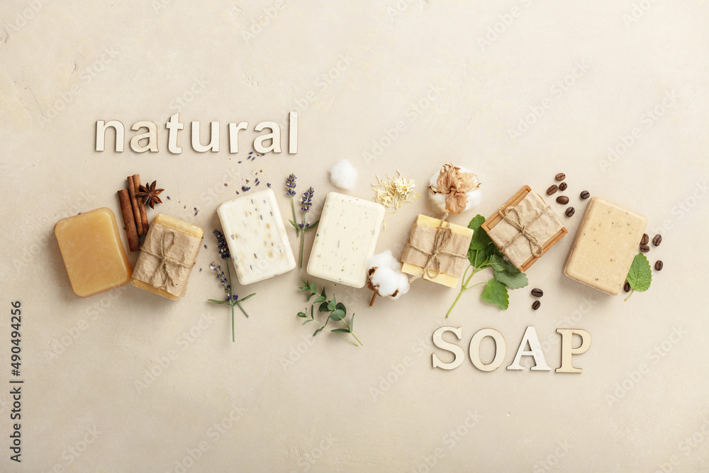 Handmade organic soap bars and ingredients on natural stone background, flat lay