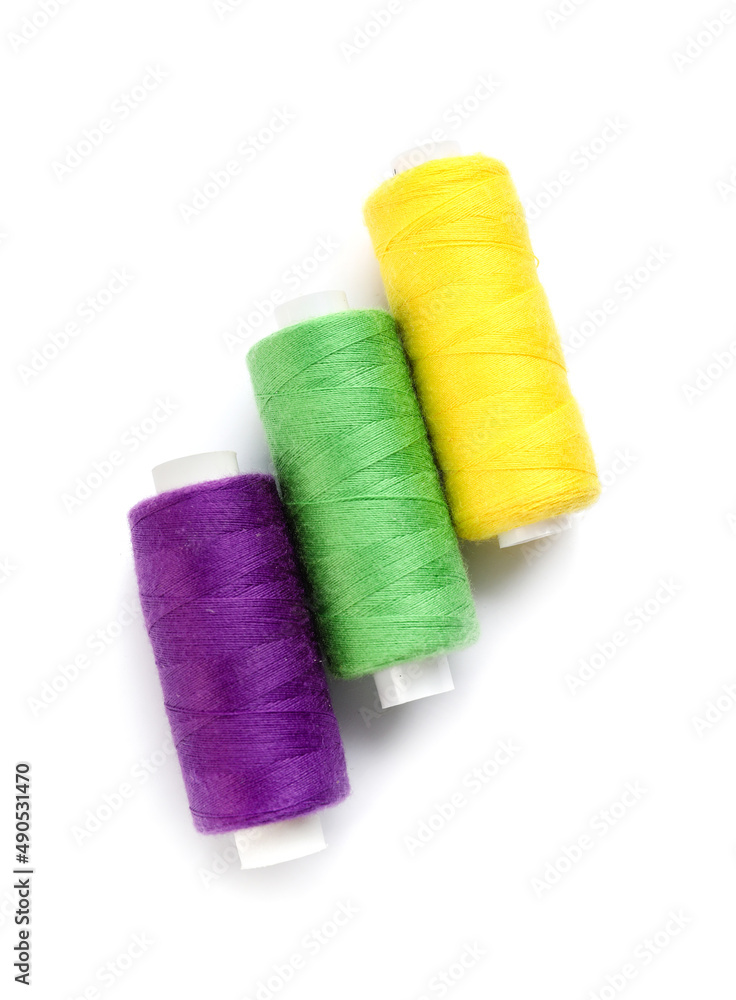 Beautiful sewing threads on white background