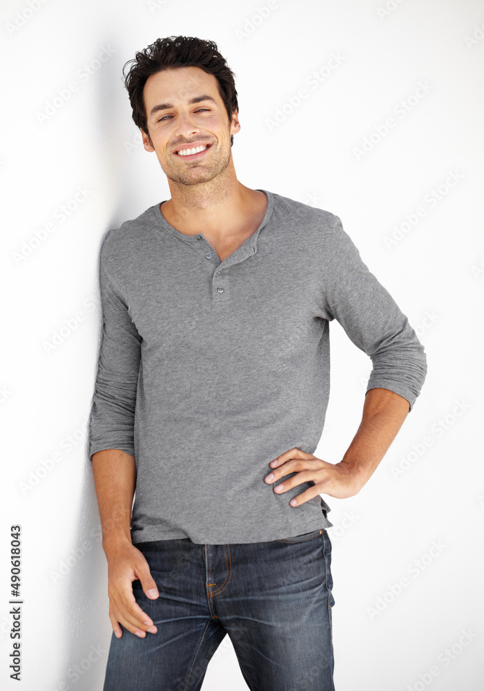 Hes got a positive outlook. Portrait of a handsome young man leaning against a wall with his hand on