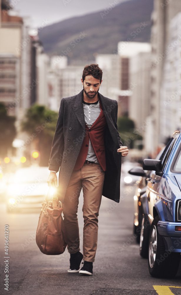 Looking stylish in the city. Full length shot of a stylish young man walking through the city.