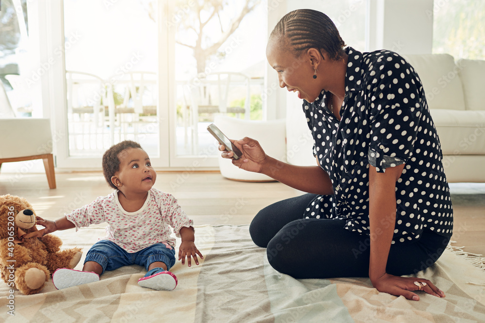 Moments to cherish. Shot of a mother taking a photo of her baby girl.