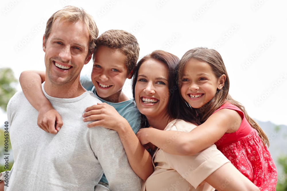 Day of family fun. Portrait of a loving family of four spending time together outdoors.