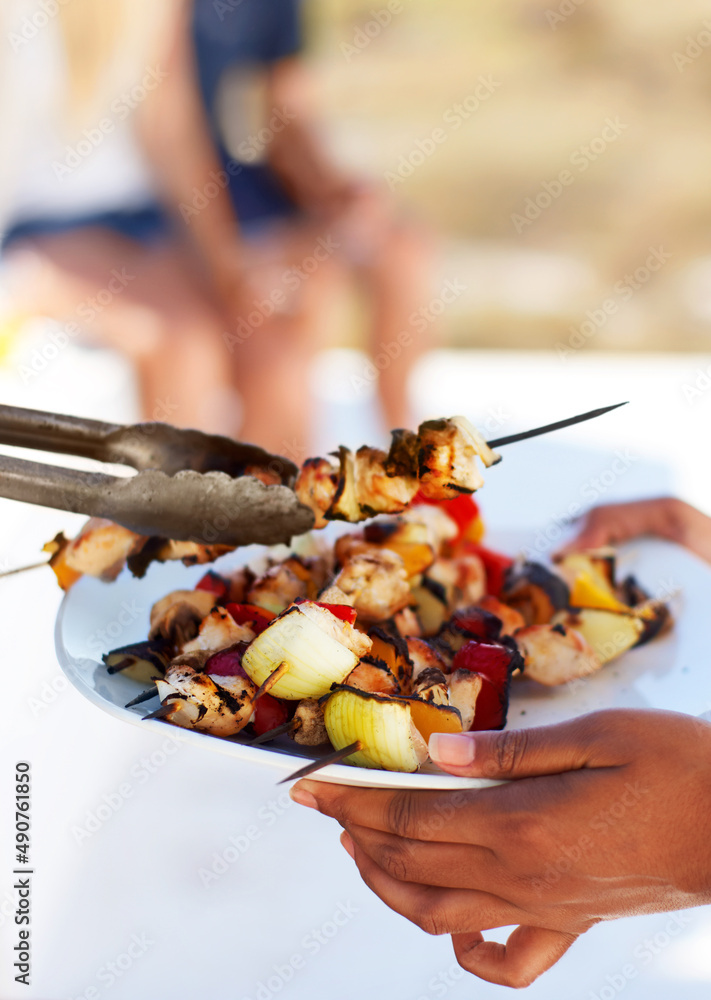 Tasty summer treats. Closeup of a plate of chicken kebabs straight from the barbeque.