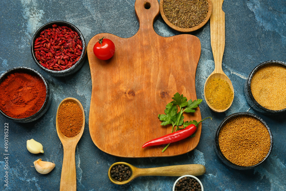 Composition with aromatic spices and wooden board on color background