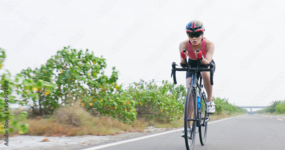 Asian young woman ride bicycle